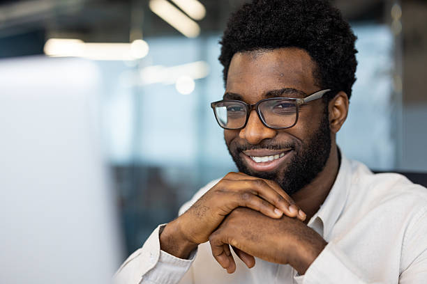 istock Confident professional posing with a smile in office setting with modern decor 2235987328