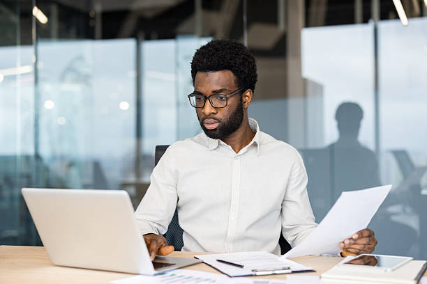 istock A focused african american businessman working in a modern office environment 2235987497