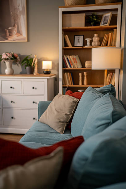 istock Cozy living room interior with sofa, bookcase, and decorations in warm evening light 2235988652