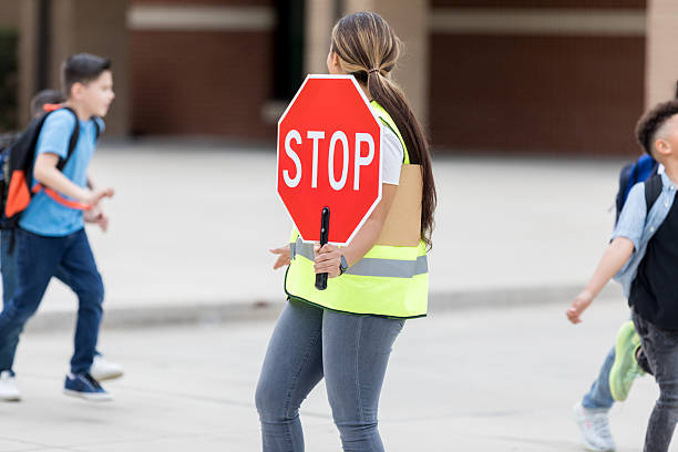 istock School Crossing Guard Directs Children Safely 2235989170