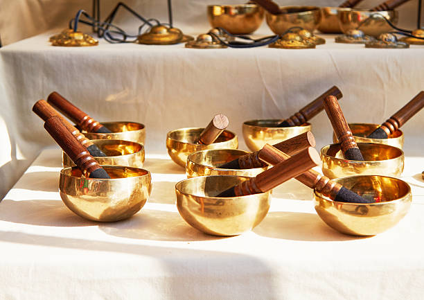 istock Collection of brass singing bowls with wooden mallets arranged on a soft fabric surface, showcasing intricate craftsmanship and inviting serene ambiance for meditation practices 2235989741