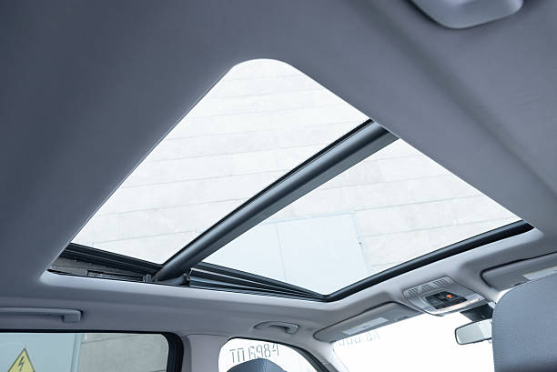 istock SUV or wagon interior with light grey headliner and panoramic roof. 2235992059