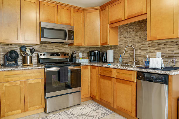 istock Modern kitchen wood cabinets stainless steel appliances 2235998874