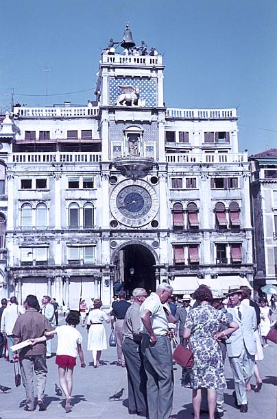 Venice, Veneto, Italy, 1960. The Torre dell'Orologio in St. Mark's Square. Furthermore: tourists and locals.