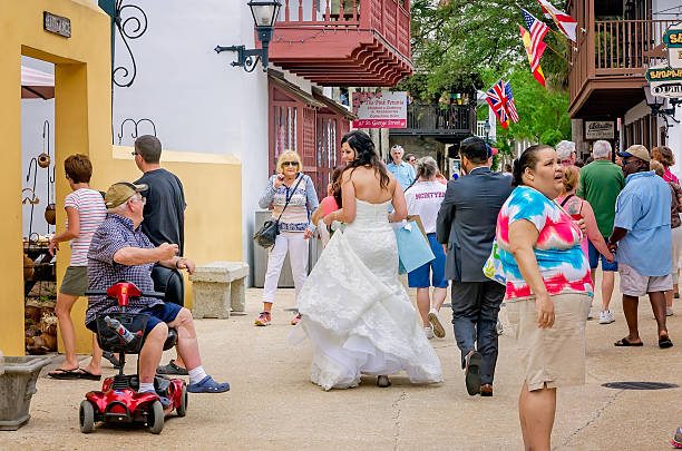 Bride Throwing Bouquet Outdoors For Guests To Catch