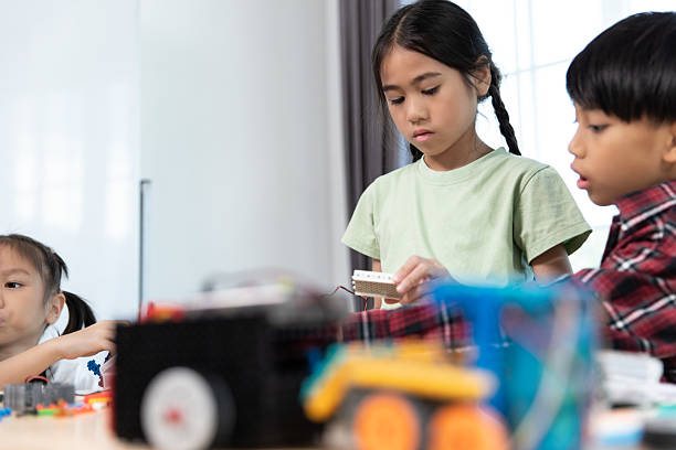 istock Diverse young students are deeply engaged in hands-on STEM learning, building and experimenting with colorful robotics construction toys under the guidance of an adult. 2236003462