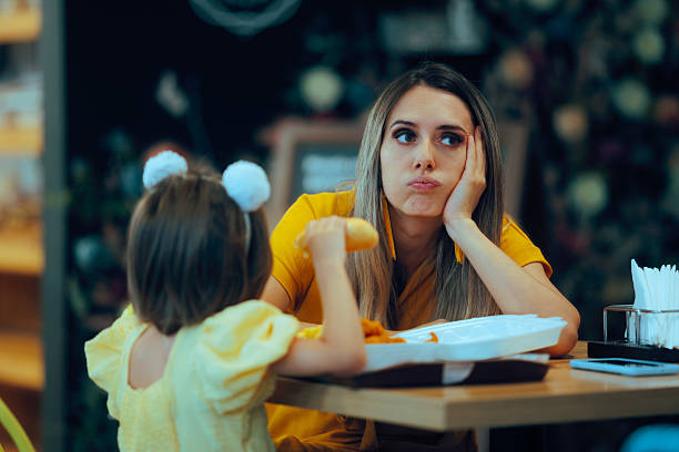 istock Bored Mom Waiting for her Little on to Finish Lunch 2236003546