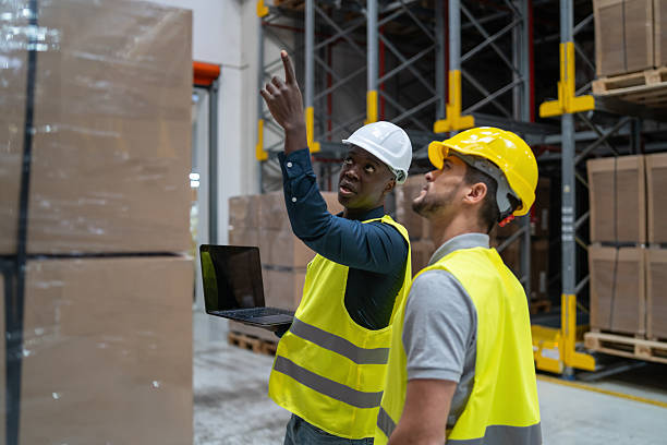 istock Warehouse Staff Inspecting Stock with Digital Device 2236005347