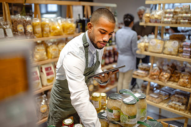 istock Multiracial Male Grocery Worker Using Digital Tablet in Organic Food Store 2236005397
