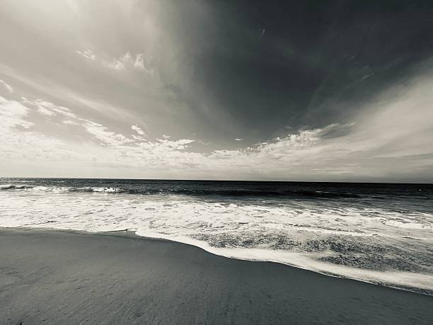 A moody sky reflected on the wet beach.