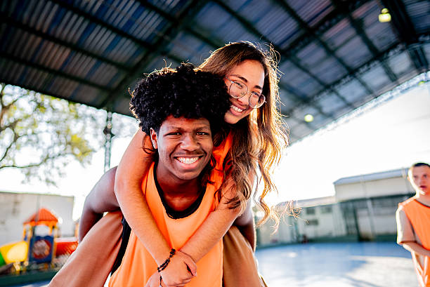 istock Students doing piggyback on a school sports court 2236008705