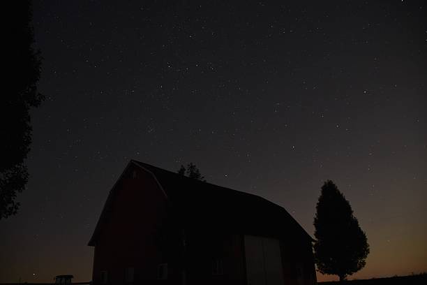 istock nighttime sky with stars and a barn in the foreground 2236009732
