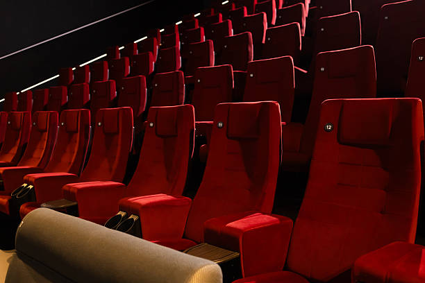 istock Empty red velvet seats waiting for spectators in a modern cinema 2236009739