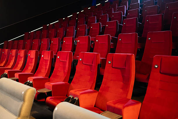 istock Rows of empty red velvet seats in a modern cinema awaiting audience 2236009758