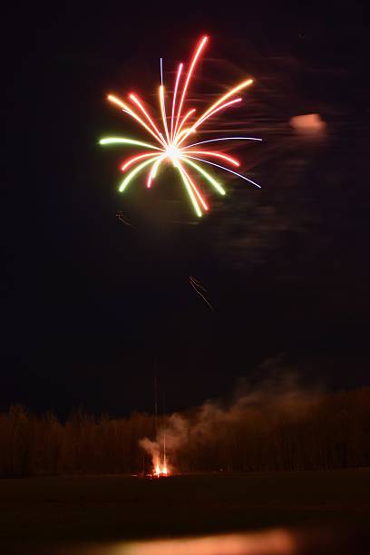 istock fireworks in the sky with a dark background and a field 2236010146