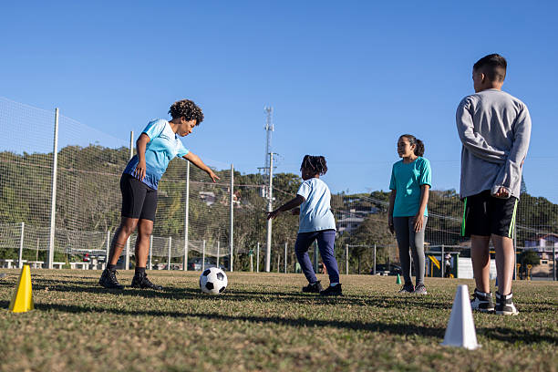 istock Soccer coach with children during training on a soccer field 2236010695