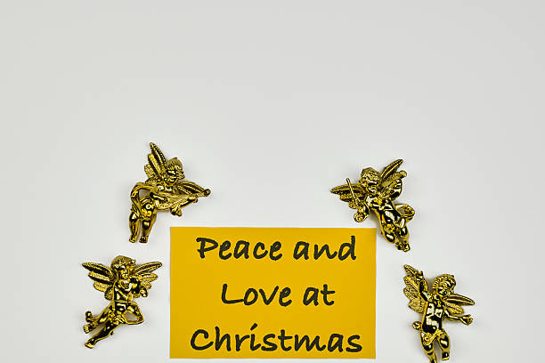 Golden angels with a Christmas wish sign, with a white background and copy space
