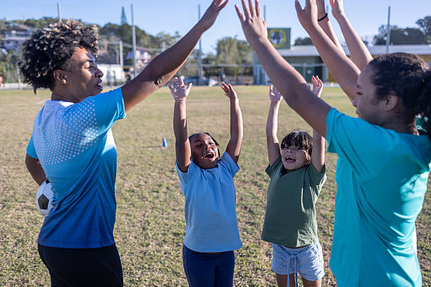 istock Coach and children cheer during soccer training 2236010820