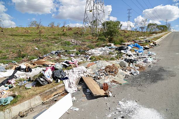 istock Irregular garbage disposal in urban areas, showing environmental pollution and lack of awareness. Ruble, furniture and plastics accumulated on the edges of the street show the impact of human neglect on the environment. 2236014599