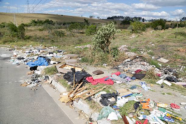 istock Irregular garbage disposal in urban areas, showing environmental pollution and lack of awareness. Ruble, furniture and plastics accumulated on the edges of the street show the impact of human neglect on the environment. 2236014629