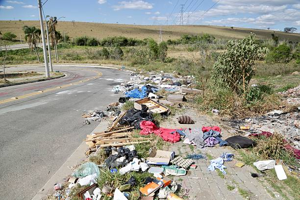 istock Irregular garbage disposal in urban areas, showing environmental pollution and lack of awareness. Ruble, furniture and plastics accumulated on the edges of the street show the impact of human neglect on the environment. 2236014640