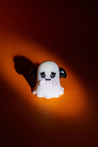 istock Halloween ghost with black bat wings on an orange background 2236015805