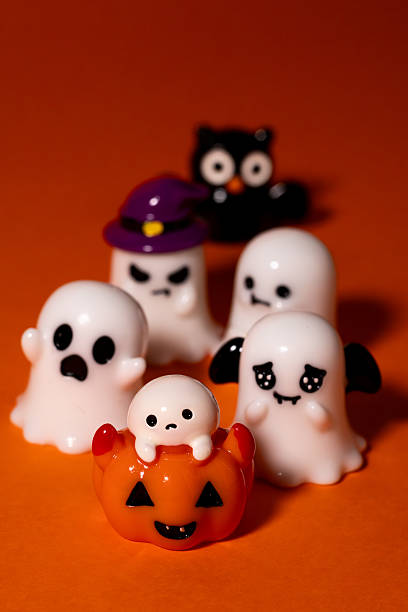 istock Group of cute Halloween figurines including ghosts, pumpkin, owl, and witch hat 2236015811