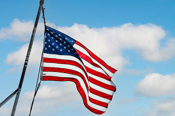 istock stars and stripes in sun with cloudy white background 2236019723