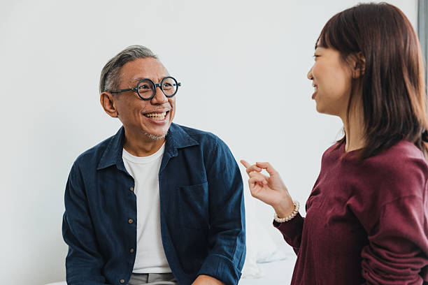 istock Smiling conversation between an older man and a woman in a bright indoor setting 2236020035