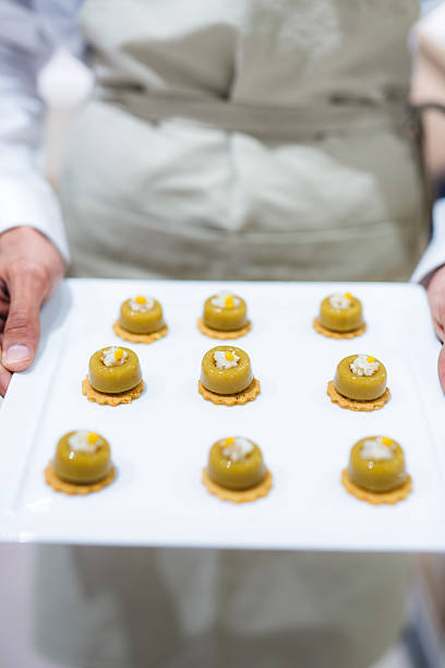 istock Chef Presenting a Platter of Nine Identical Gourmet Appetizers 2236025208