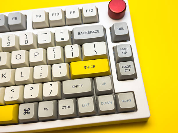 istock White mechanical keyboard with bright Enter key on bright yellow background, minimalism, keyboard buttons. A keyboard with a yellow key on the bottom left 2236026986