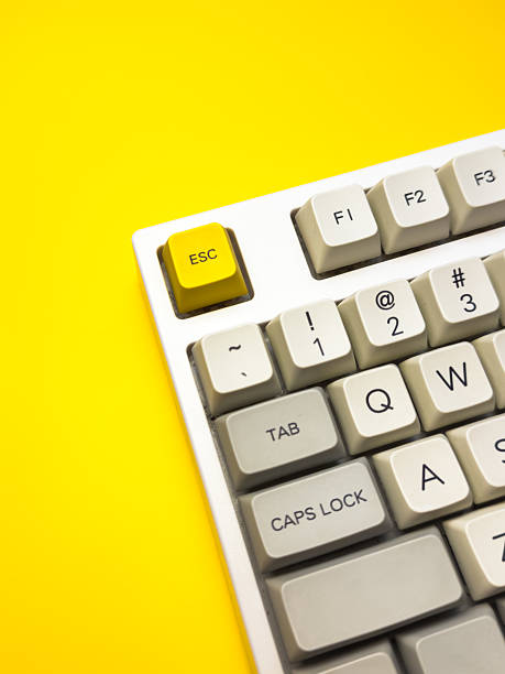 istock White mechanical keyboard with bright Esc key on bright yellow background, minimalism, keyboard buttons. A keyboard with a yellow key on the bottom left 2236026995
