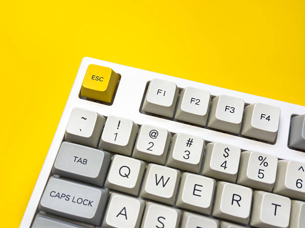 istock White mechanical keyboard with bright Esc key on bright yellow background, minimalism, keyboard buttons. A keyboard with a yellow key on the bottom left 2236027015