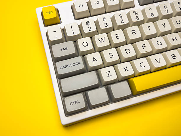 istock White mechanical keyboard with bright Esc key on bright yellow background, minimalism, keyboard buttons. A keyboard with a yellow key on the bottom left 2236027026