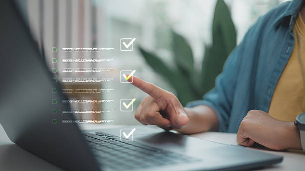 istock Finger pointing at a digital checklist interface on a laptop screen. Concept of task management, productivity planning, online workflow organization, and digital to-do list system. 2236027661