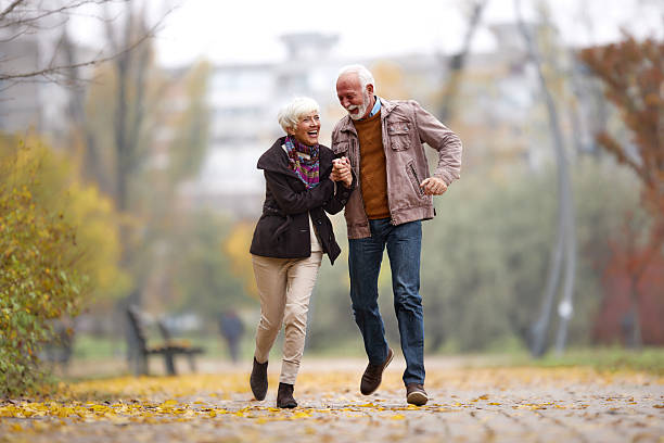 istock Cheerful mature couple having fun while running in the park. 2236028601