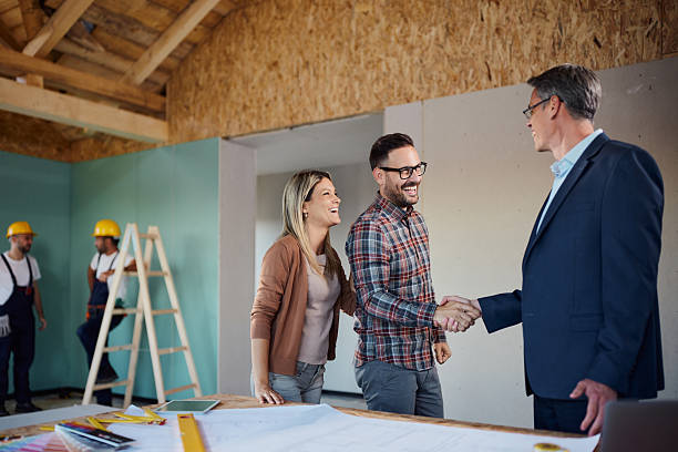 istock Happy couple came to an agreement with architect at construction site. 2236029227