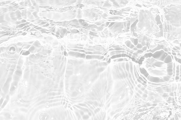 istock White water with ripples on the surface. Defocus blurred transparent white colored clear calm water surface texture with splashes and bubbles. Water waves with shining pattern texture background. 2236030311