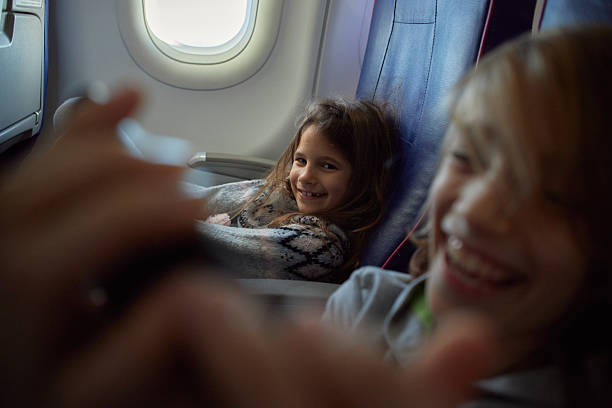 istock Children playing games while traveling by airplane 2236032834