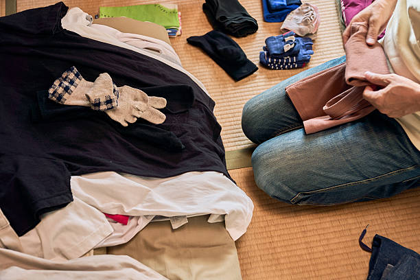istock A sequence of photos showing a man folding laundry on tatami mat. 2236033178