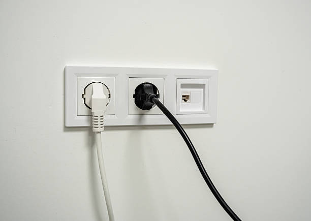 istock White wall electrical sockets showing plugged and unplugged power cables and internet ethernet cable hanging down, representing modern connectivity and energy supply 2236034152