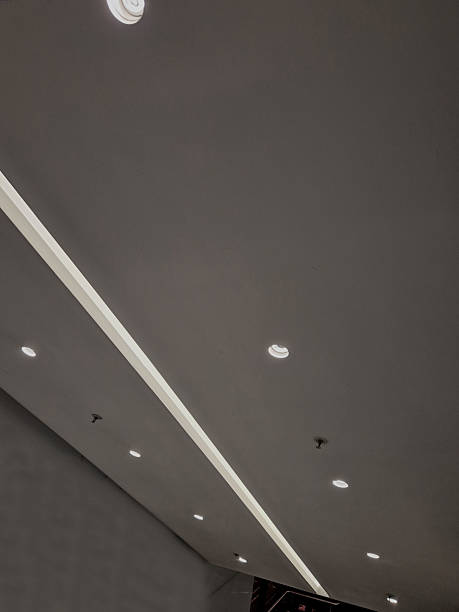 istock soffit with a cornice illuminated by LED strips in the arch. walls lined with brown wooden plywood. light cones make a festive impression. a night club with a great reputation and atmosphere, hall 2236036000