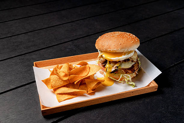 istock Gourmet Hamburger Topped with a Fried Egg and Runny Yolk 2236038139