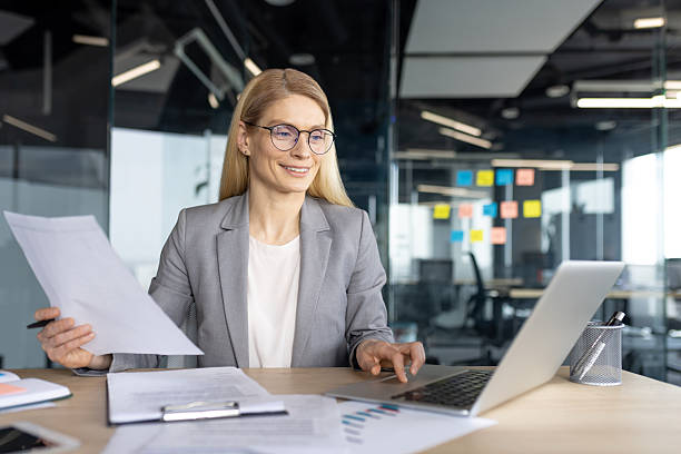 istock Professional businesswoman working in a modern office environment with documents and laptop 2236038632
