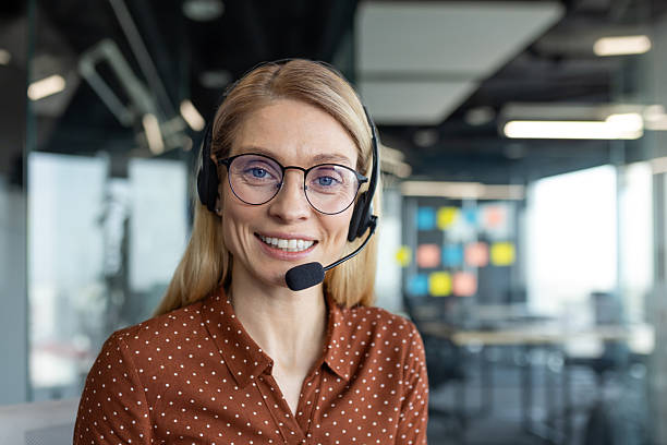 istock Smiling customer service woman wearing a headset in a modern office 2236038683