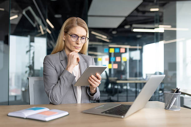 istock Professional businesswoman using tablet in modern office workspace for work 2236038697