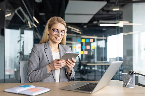 istock Businesswoman working on a tablet in a modern office, focused and determined. 2236038699