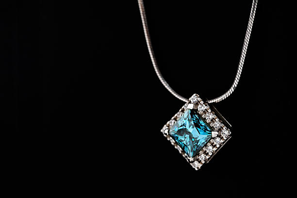 istock A blue diamond necklace sits on a black surface 2236038806