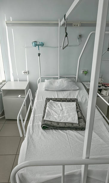 istock medical interior of a white ward with a bed and bedside table, top view 2236043882