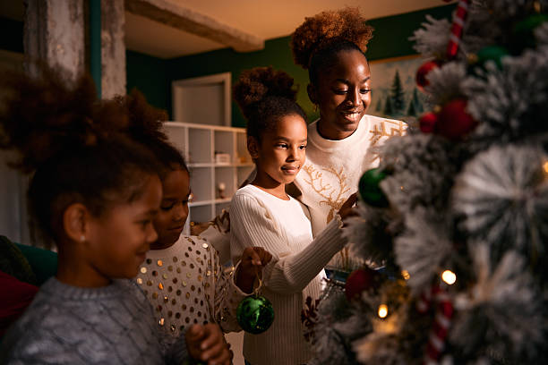 istock African American mother and daughters decorating Christmas tree 2236044985